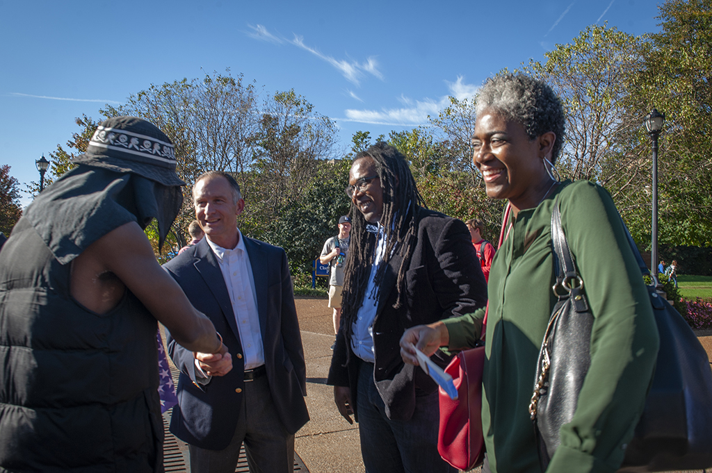 A photo of Dr. Jonathan Smith, SLU adminisrators and an activist near the clock tower in 2014