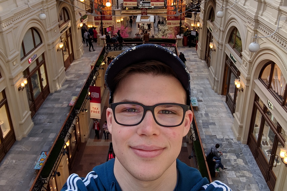 A selfie of Jake Bernstein taken from above a busy shopping area.