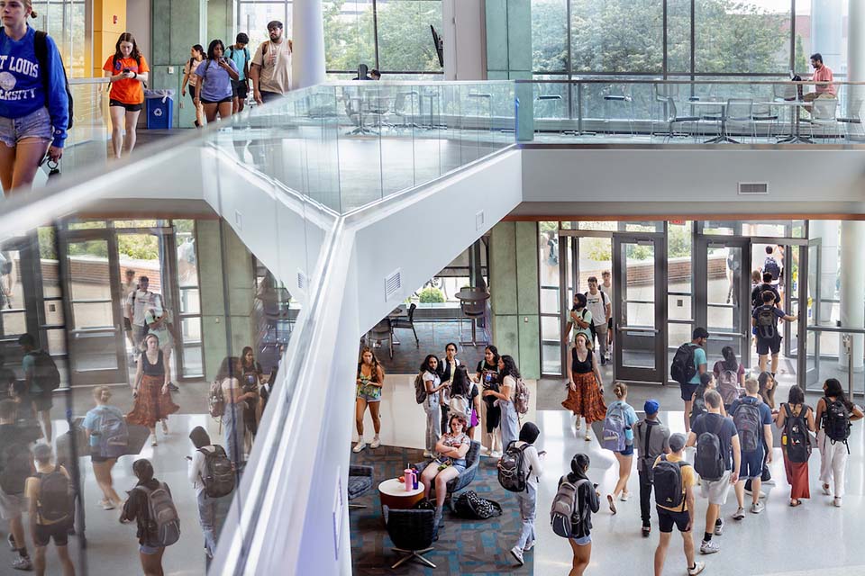 Students walk back and forth in the lobby of the Science and Engineering Building.