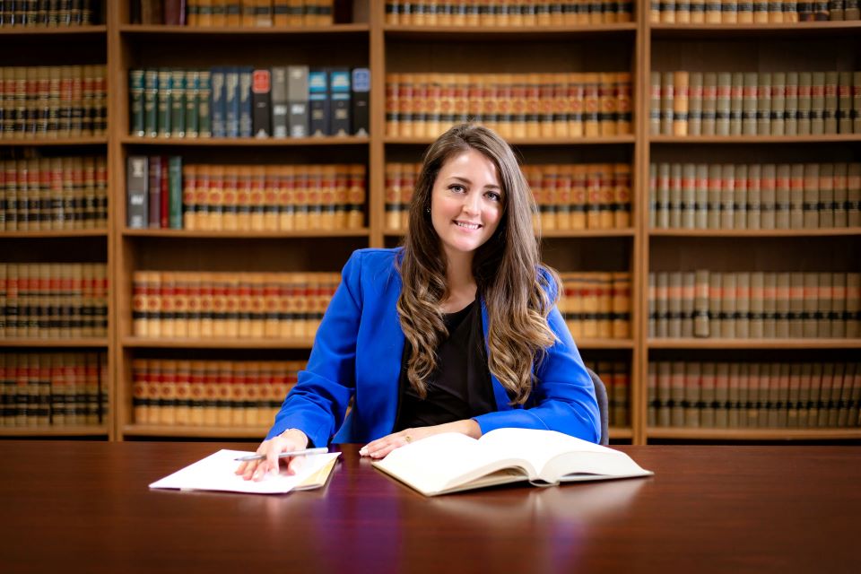 Letitia Wiggins poses in her office in Illinois Letitia Wiggins poses at a table with books open, in front of shelves of law books.