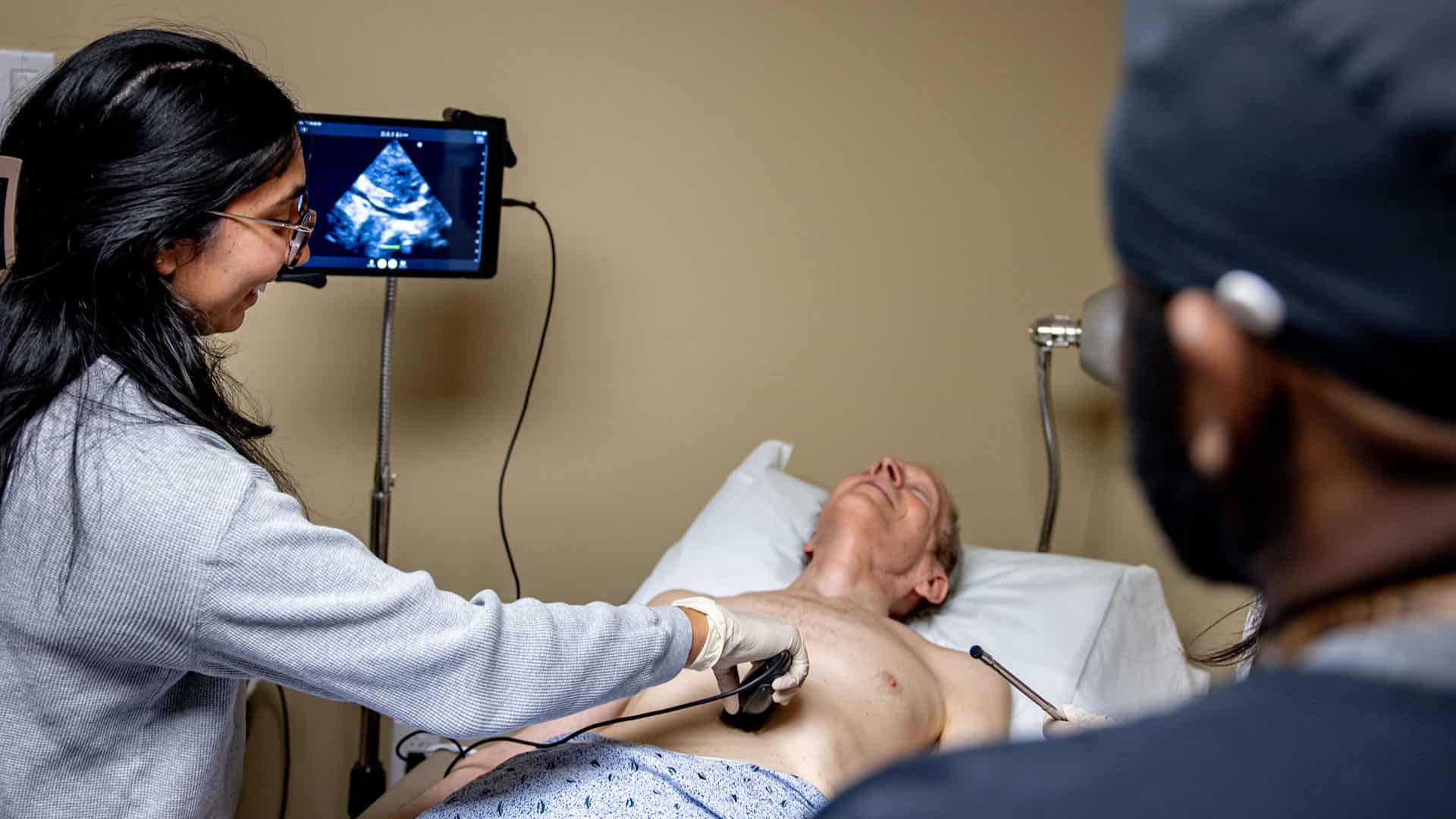 A student examines a patient using an ultrasound machine in the Clinical Skills Center.