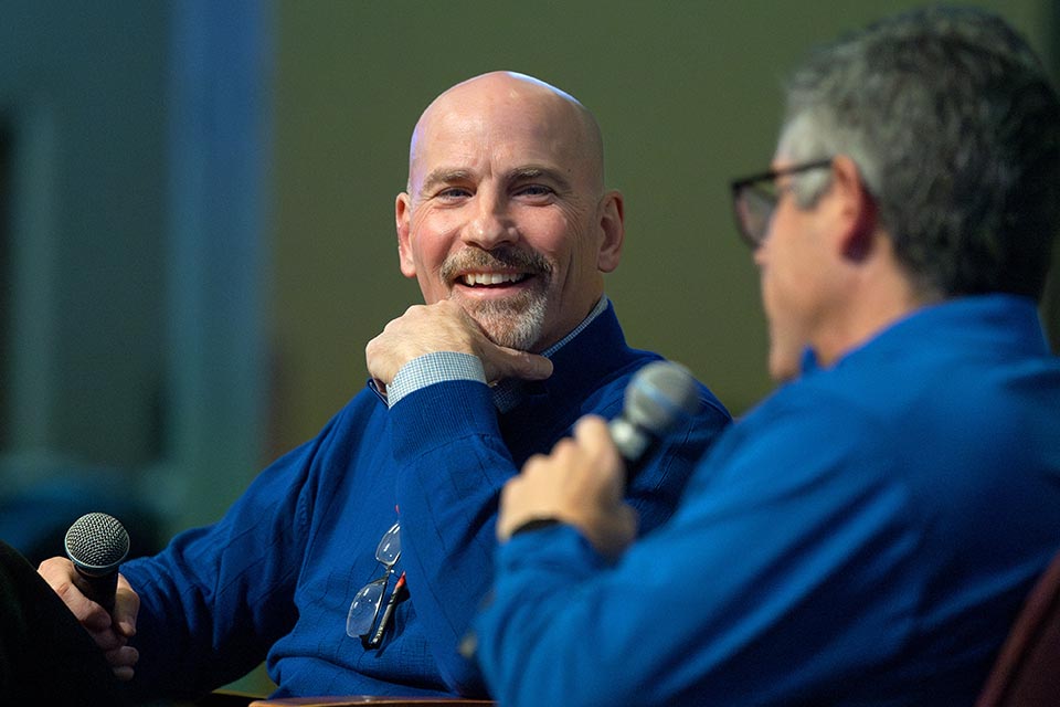 Feser Question and Answer a man in blue shirt smiling at another man