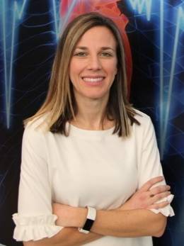 Jenna Gorlewicz's headshot where she is staring straight at the camera smiling and has her arms crossed in front of her.