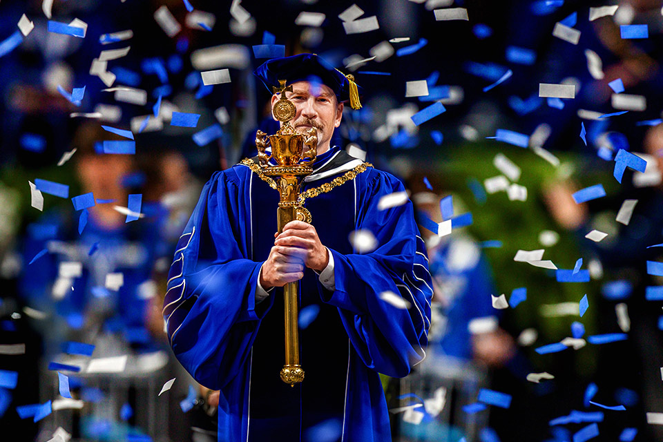 Dr. Ed Feser carries SLU's presidential mace during his inauguration in November 2025.